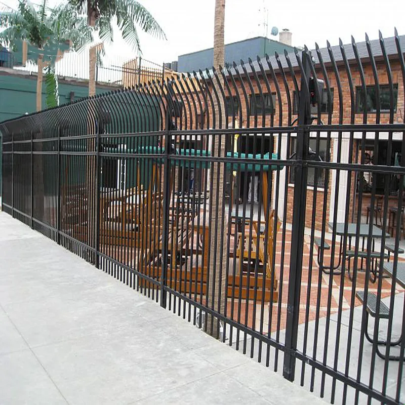 Bent top metal security fence installed around a property boundary