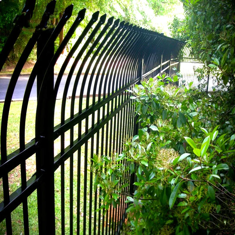 Bent top metal security fence line installed beside a road