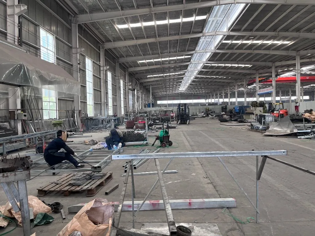 Wide fence factory workshop with finished mesh and wire rolls