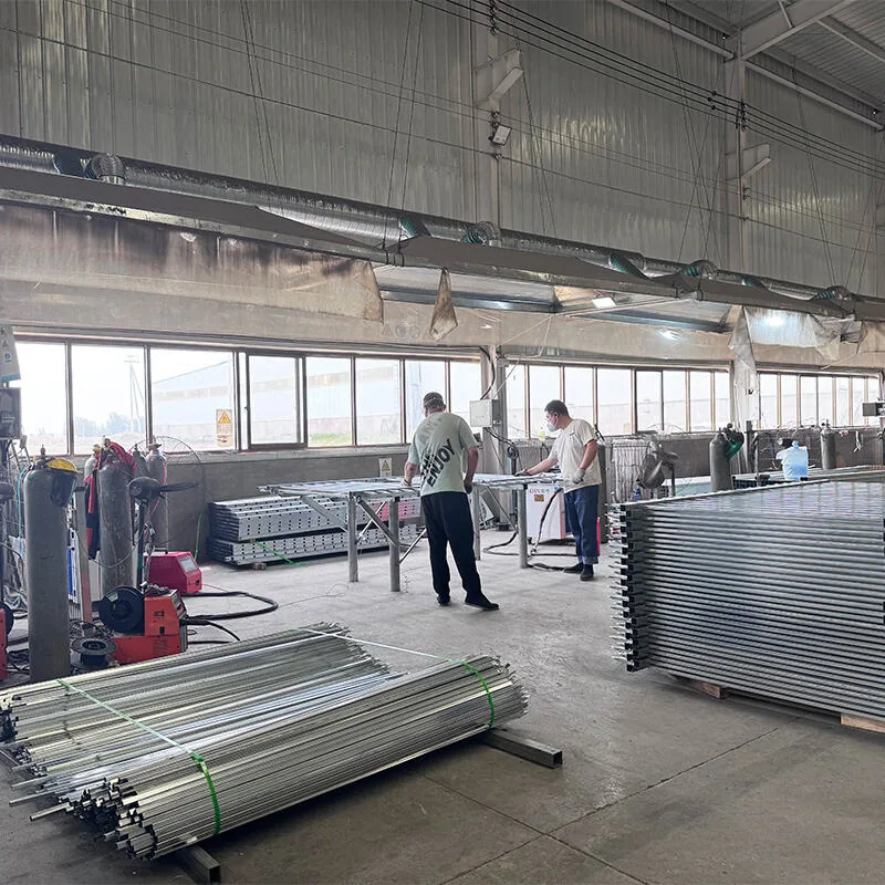 Workers welding fence panels in the workshop