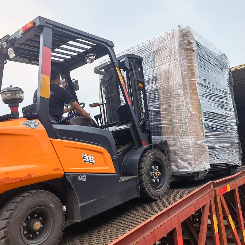 Forklift loading packed fence products into container