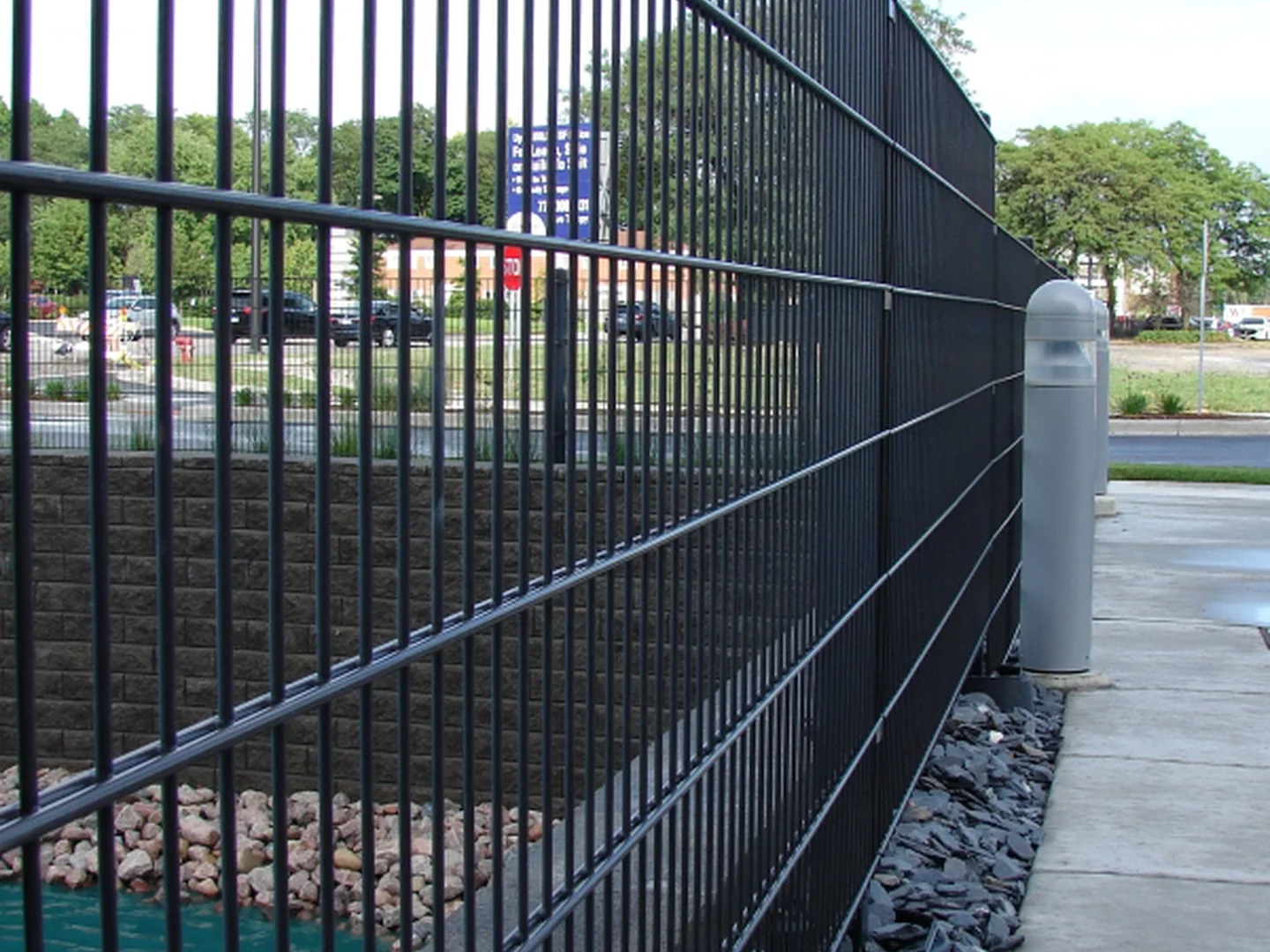 Black coated double wire fence finish shown around a commercial site