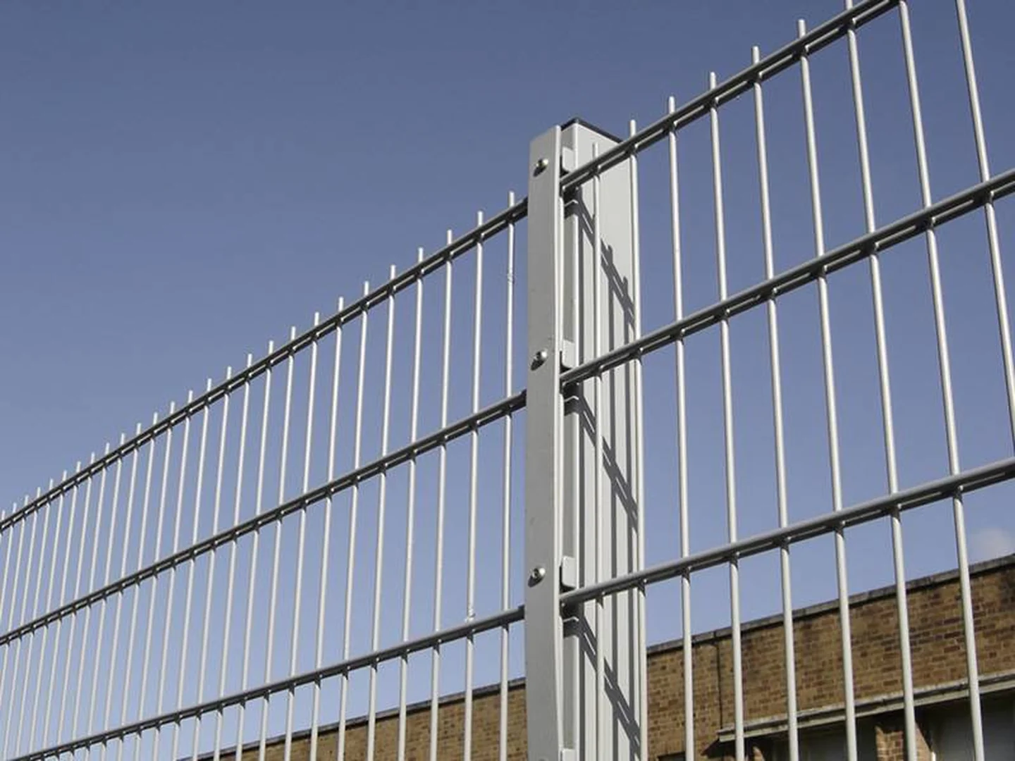 Galvanized double wire fence finish shown in an outdoor perimeter scene